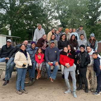 A large family is gathered for a hay ride at Wolf Lake Ranch!