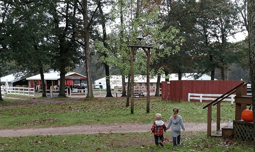 This is a photo of two young children walking around Wolf Lake Ranch. 