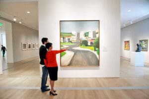 People looking at a painting in the Grand Rapids Art Museum