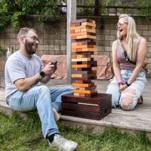 Couple playing giant Jenga at John Ball Zoo Roaring Nights event 2022