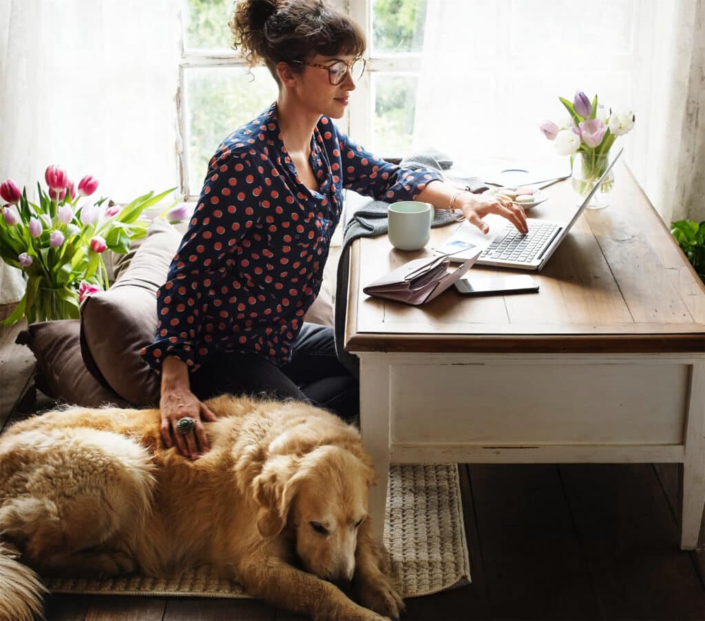 woman working from home with dog