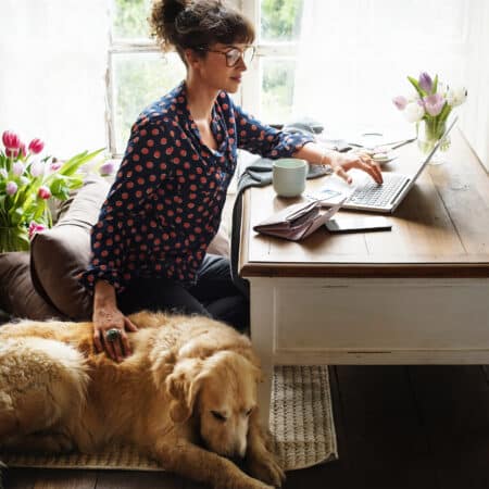 woman working from home with dog